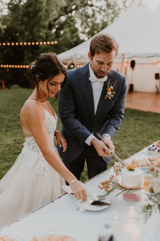 couple cutting cake at intimate wedding